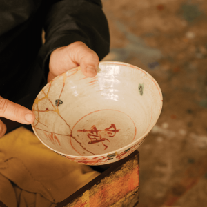 Mako Fujimura holds a bowl with golden kintsugi cracks. 