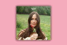 The image shows the cover of Kacey Musgraves' album "Deeper Well," in which she is holding a red flower. 