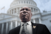 Ben Crump, dressed in a suit, looks up and away from the camera. The U.S. Capitol is in the background. 